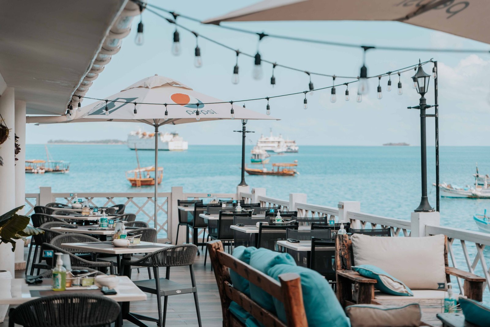 Relaxing dining by the ocean in Zanzibar with stunning sea views and cozy seating.